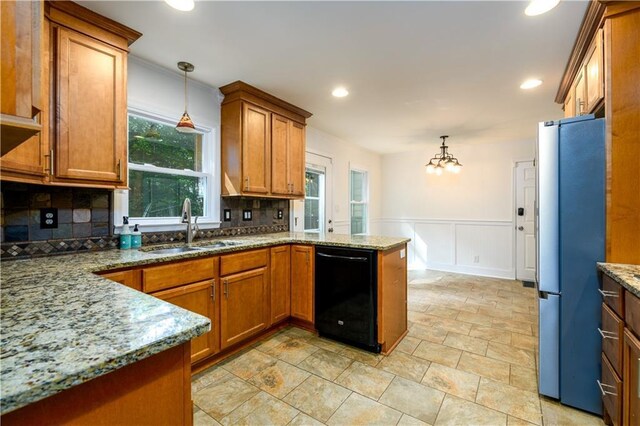 4324 Japonica Ct SW, Lilburn, GA 30047 - kitchen featuring brown cabinets, decorative backsplash, stone countertops, ornamental molding, and a decorative wall