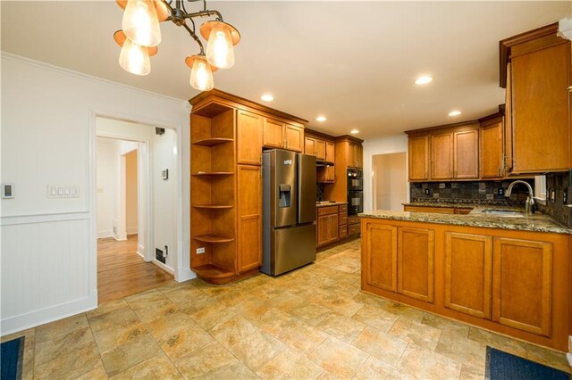 4324 Japonica Ct SW, Lilburn, GA 30047 - kitchen with stainless steel fridge with ice dispenser, under cabinet range hood, backsplash, gas cooktop, and light stone countertops