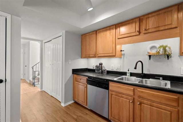 kitchen with sink, light hardwood / wood-style flooring, and stainless steel dishwasher