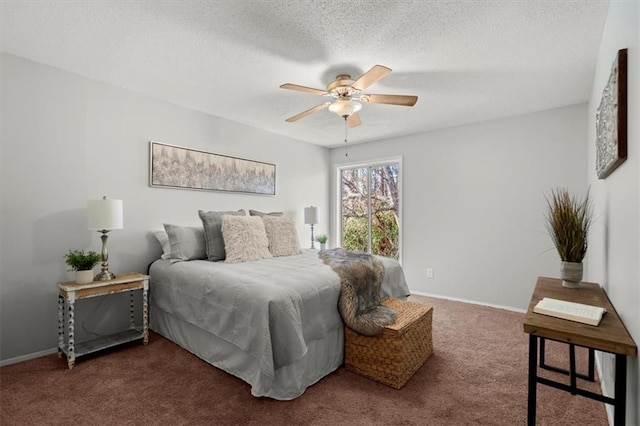 carpeted bedroom with ceiling fan and a textured ceiling