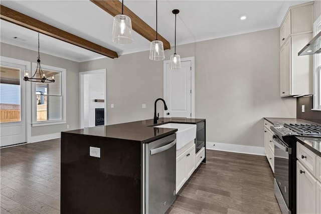 kitchen featuring black gas range oven, dark countertops, a sink, and stainless steel dishwasher