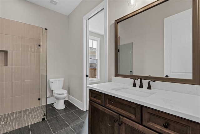 full bathroom featuring visible vents, toilet, tile patterned flooring, a tile shower, and vanity