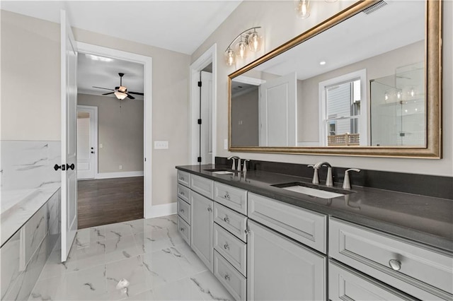 full bathroom with marble finish floor, baseboards, visible vents, and a sink