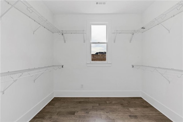 walk in closet with dark wood-style floors and visible vents