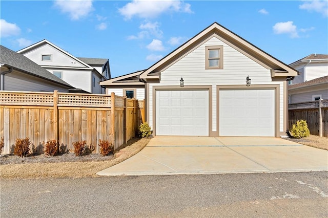 view of front of home with a garage and fence