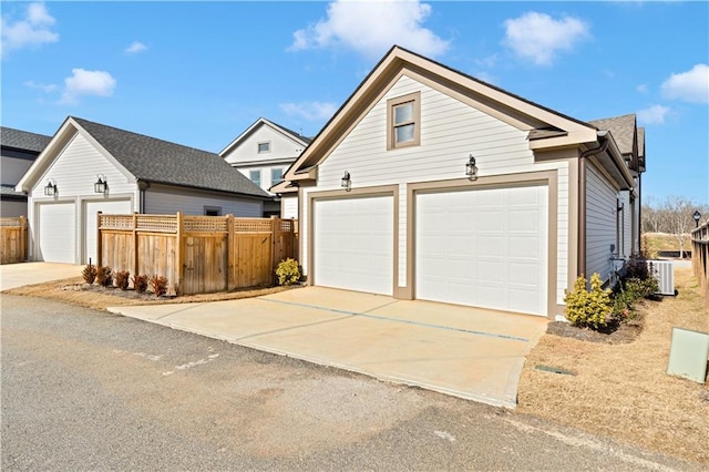 view of front of property with a garage, fence, and an outdoor structure