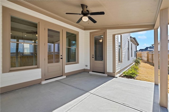 view of patio / terrace with fence and a ceiling fan