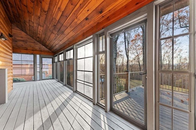 unfurnished sunroom featuring lofted ceiling and wood ceiling