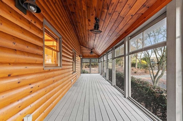 unfurnished sunroom featuring lofted ceiling and wooden ceiling