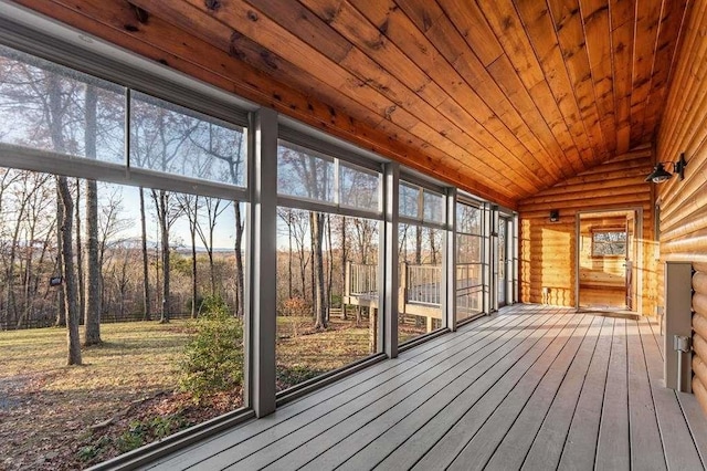 unfurnished sunroom featuring lofted ceiling and wood ceiling