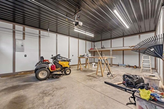 garage with electric panel and a garage door opener