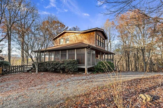 view of side of home with a sunroom