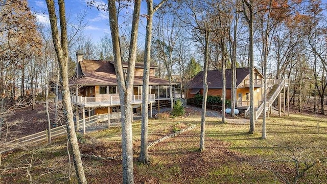 exterior space with a sunroom and a lawn