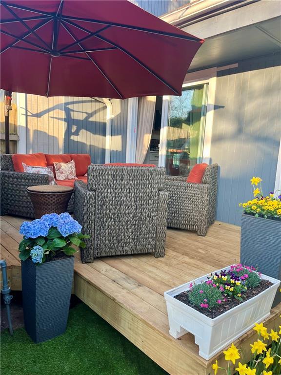 wooden terrace featuring outdoor lounge area