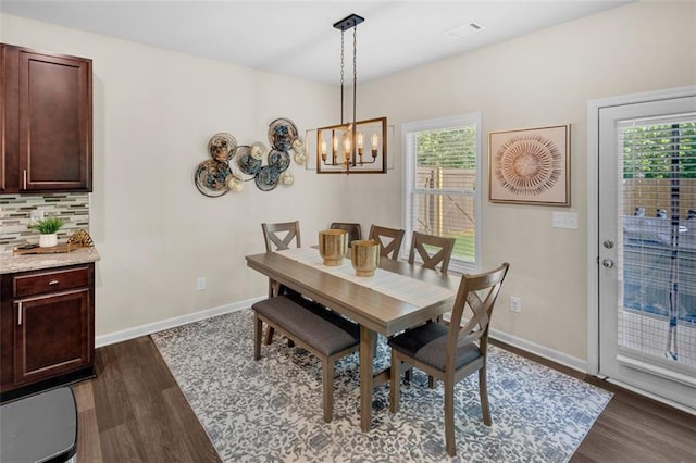 104 Auburn Crossing Way, Auburn, GA 30011 - dining space featuring dark wood-type flooring, a chandelier, and baseboards