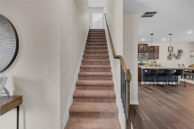 104 Auburn Crossing Way, Auburn, GA 30011 - staircase featuring wood finished floors, baseboards, and recessed lighting
