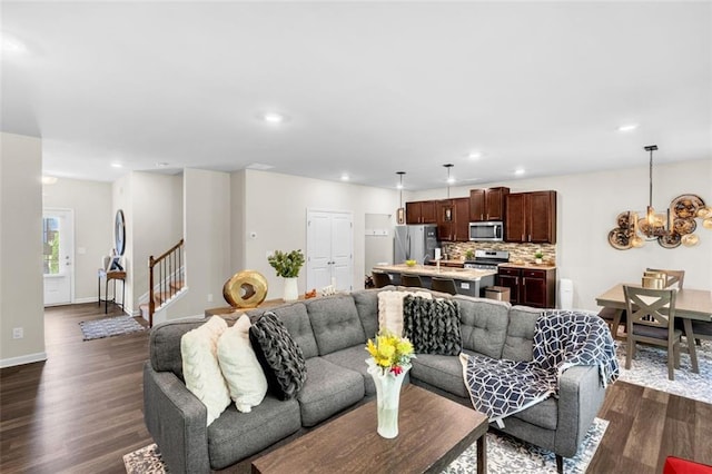 104 Auburn Crossing Way, Auburn, GA 30011 - living room with stairway, a chandelier, dark wood-type flooring, recessed lighting, and baseboards