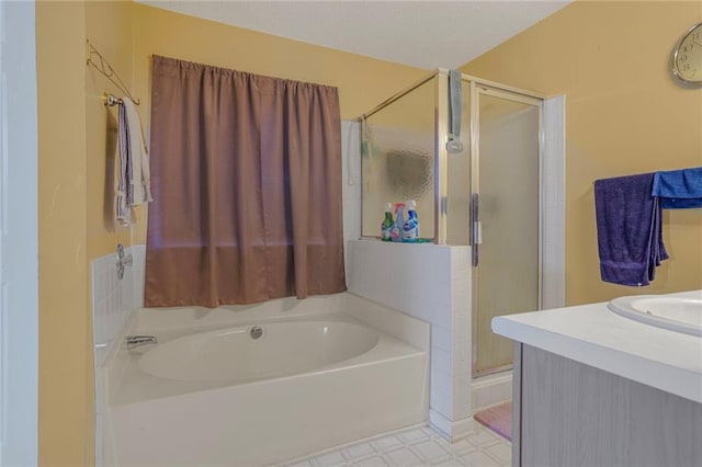 full bath with a stall shower, vanity, a bath, and tile patterned floors