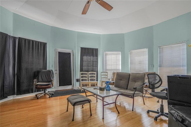 office area with a ceiling fan, a towering ceiling, and hardwood / wood-style flooring