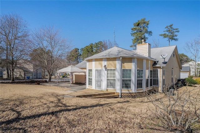 back of property featuring a chimney