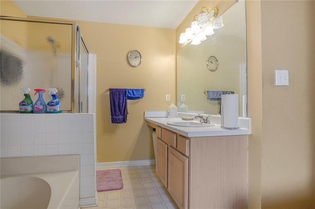 full bathroom with a stall shower, vanity, a bath, baseboards, and tile patterned floors