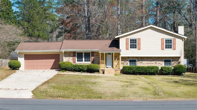 tri-level home with concrete driveway, an attached garage, a front yard, brick siding, and a chimney