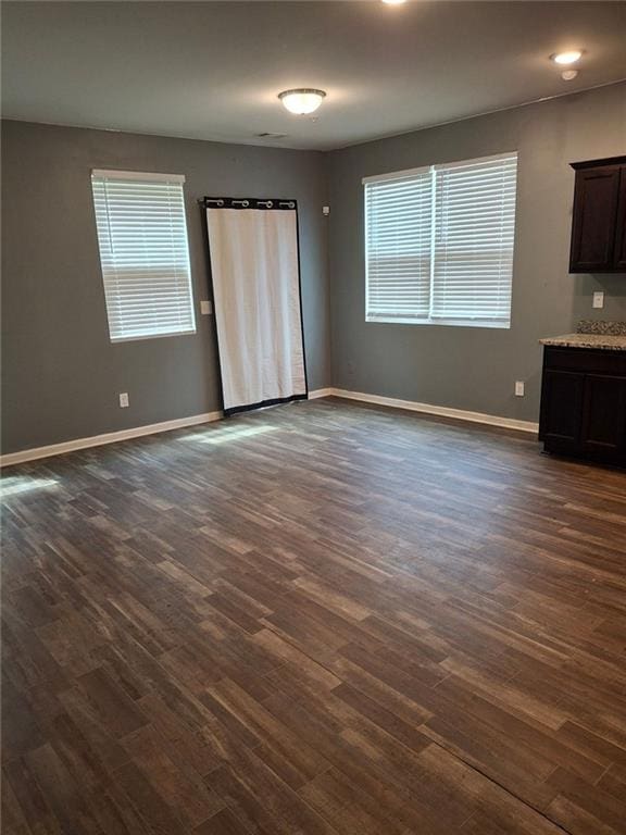 interior space with dark wood-type flooring and a wealth of natural light