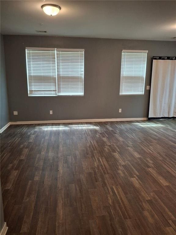 unfurnished room featuring dark hardwood / wood-style flooring