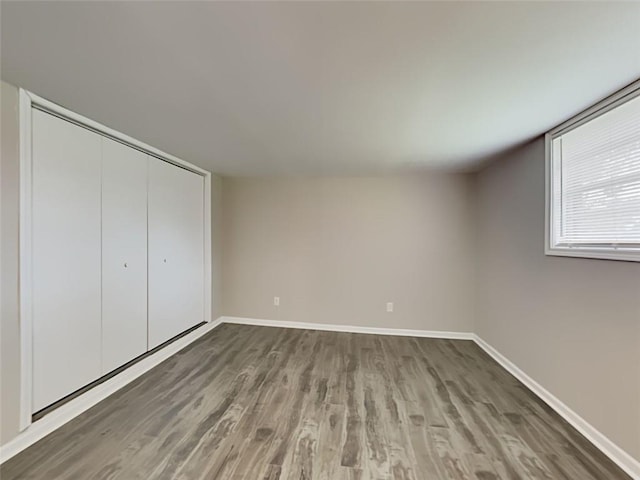 908 Kennesaw Dr, Forest Park, GA 30297 - unfurnished bedroom with wood finished floors, baseboards, and a closet
