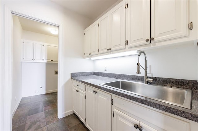 kitchen featuring sink and white cabinets