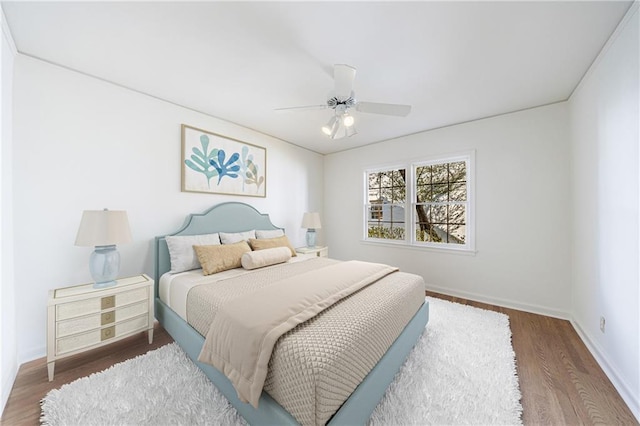 bedroom with ceiling fan and dark hardwood / wood-style floors