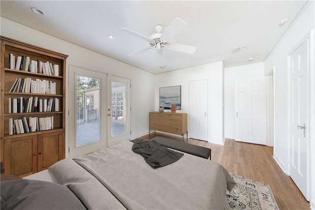 bedroom with access to outside, ceiling fan, french doors, and light hardwood / wood-style flooring