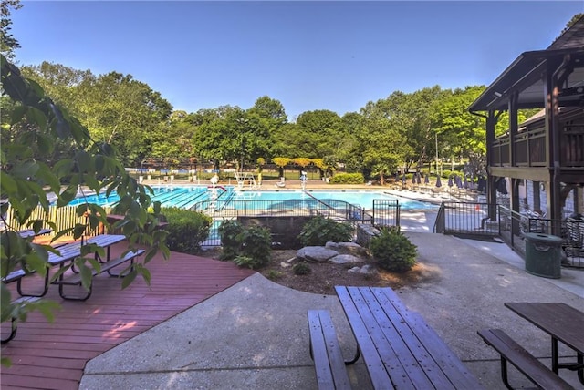 view of swimming pool featuring a patio and a deck