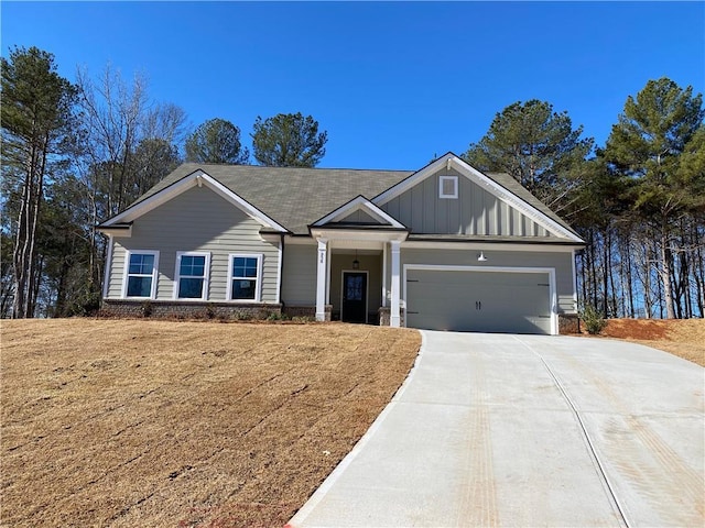 258 Westminster Ct, Winder, GA 30680 - craftsman-style home with board and batten siding, an attached garage, and concrete driveway