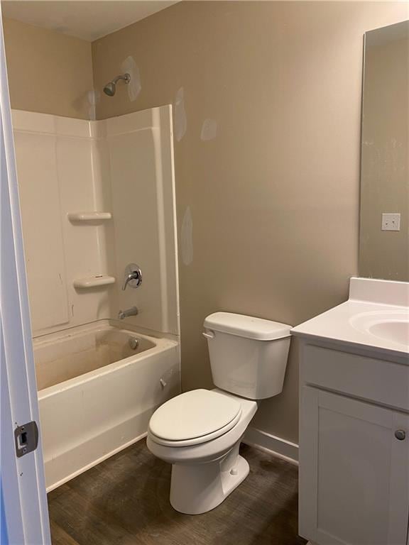 258 Westminster Ct, Winder, GA 30680 - full bathroom featuring vanity, toilet, tub / shower combination, wood finished floors, and baseboards