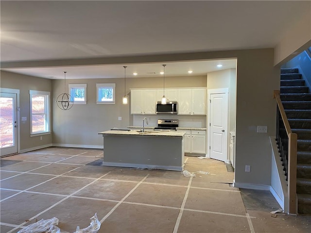 258 Westminster Ct, Winder, GA 30680 - kitchen with stainless steel appliances, white cabinets, baseboards, light countertops, and recessed lighting