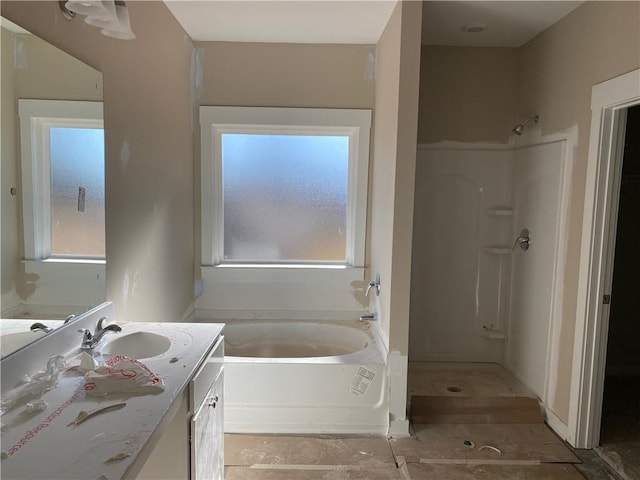 258 Westminster Ct, Winder, GA 30680 - full bathroom featuring healthy amount of natural light, vanity, a bath, and a shower