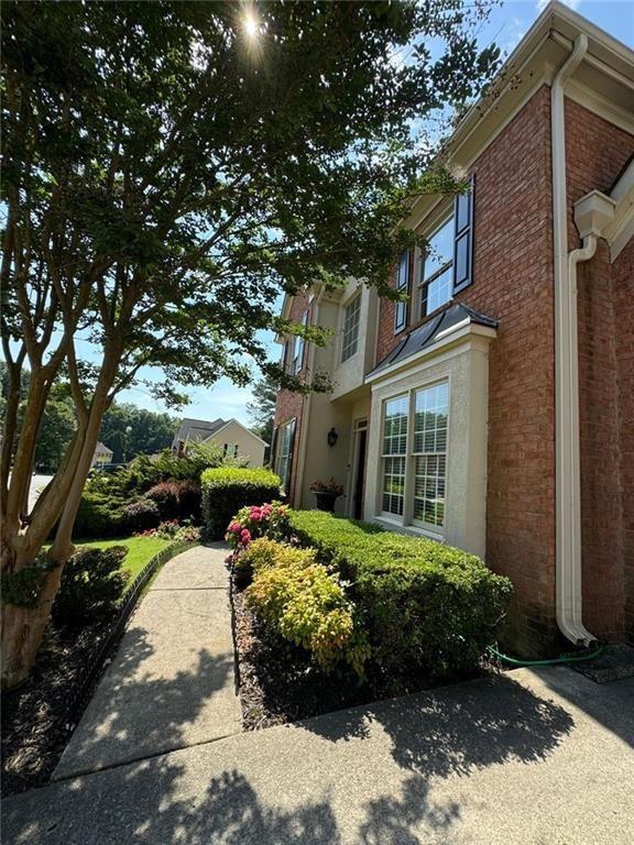 view of side of property featuring brick siding