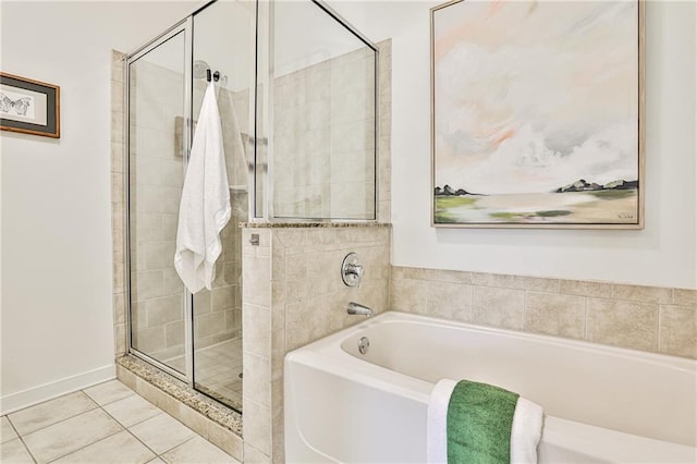 bathroom with tile patterned floors and independent shower and bath