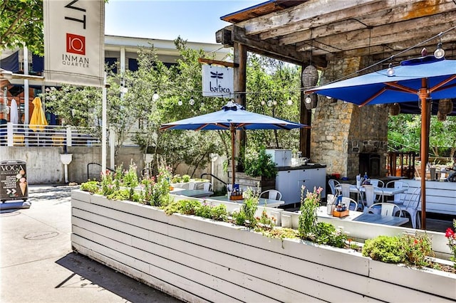 view of patio featuring an outdoor stone fireplace