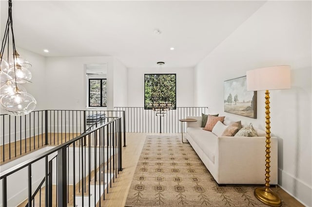 living area featuring recessed lighting, an inviting chandelier, and light wood-style floors