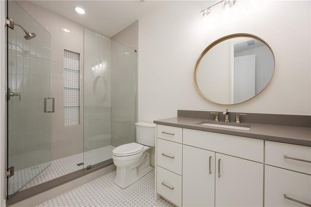 full bath featuring toilet, a stall shower, and vanity