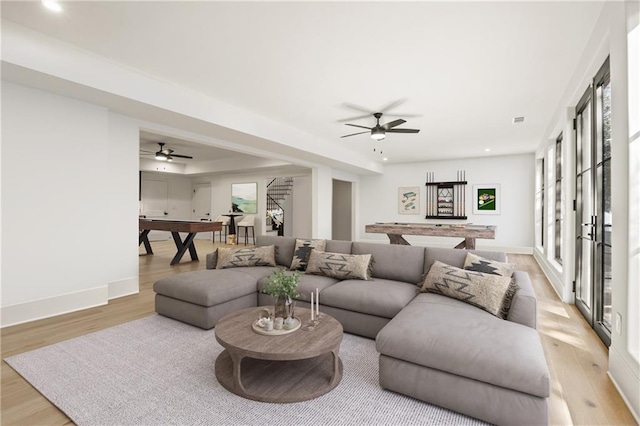 5060 Lake Forrest Dr, Atlanta, GA 30342 - living area featuring stairs, light wood-style floors, ceiling fan, recessed lighting, and baseboards