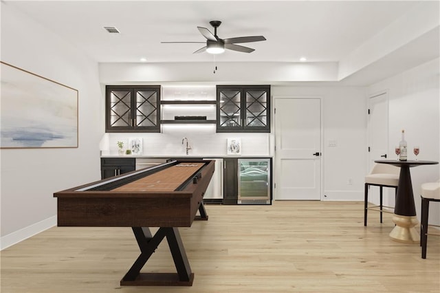 5060 Lake Forrest Dr, Atlanta, GA 30342 - indoor wet bar featuring wine cooler, light wood-type flooring, tasteful backsplash, ceiling fan, and recessed lighting