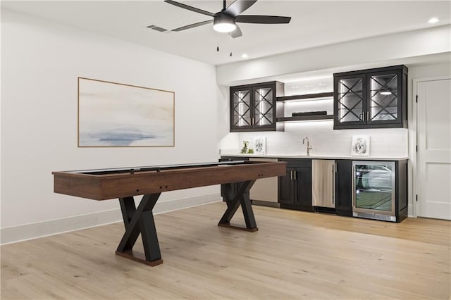 5060 Lake Forrest Dr, Atlanta, GA 30342 - indoor wet bar with beverage cooler, recessed lighting, tasteful backsplash, light wood-style flooring, and a ceiling fan