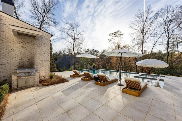 view of patio with an outdoor pool and area for grilling