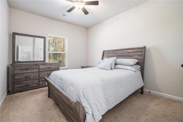 bedroom featuring visible vents, baseboards, and light carpet