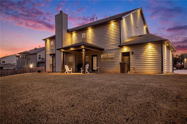 exterior space with fence and a chimney