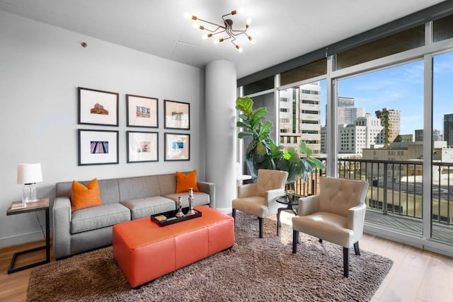 interior space with a wall of windows, an inviting chandelier, and hardwood / wood-style floors