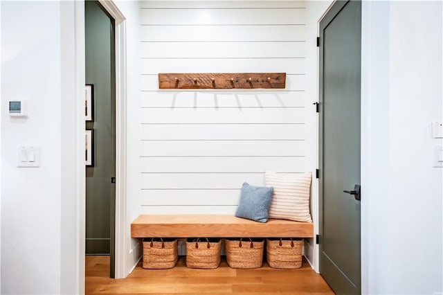 mudroom featuring wooden walls and wood finished floors